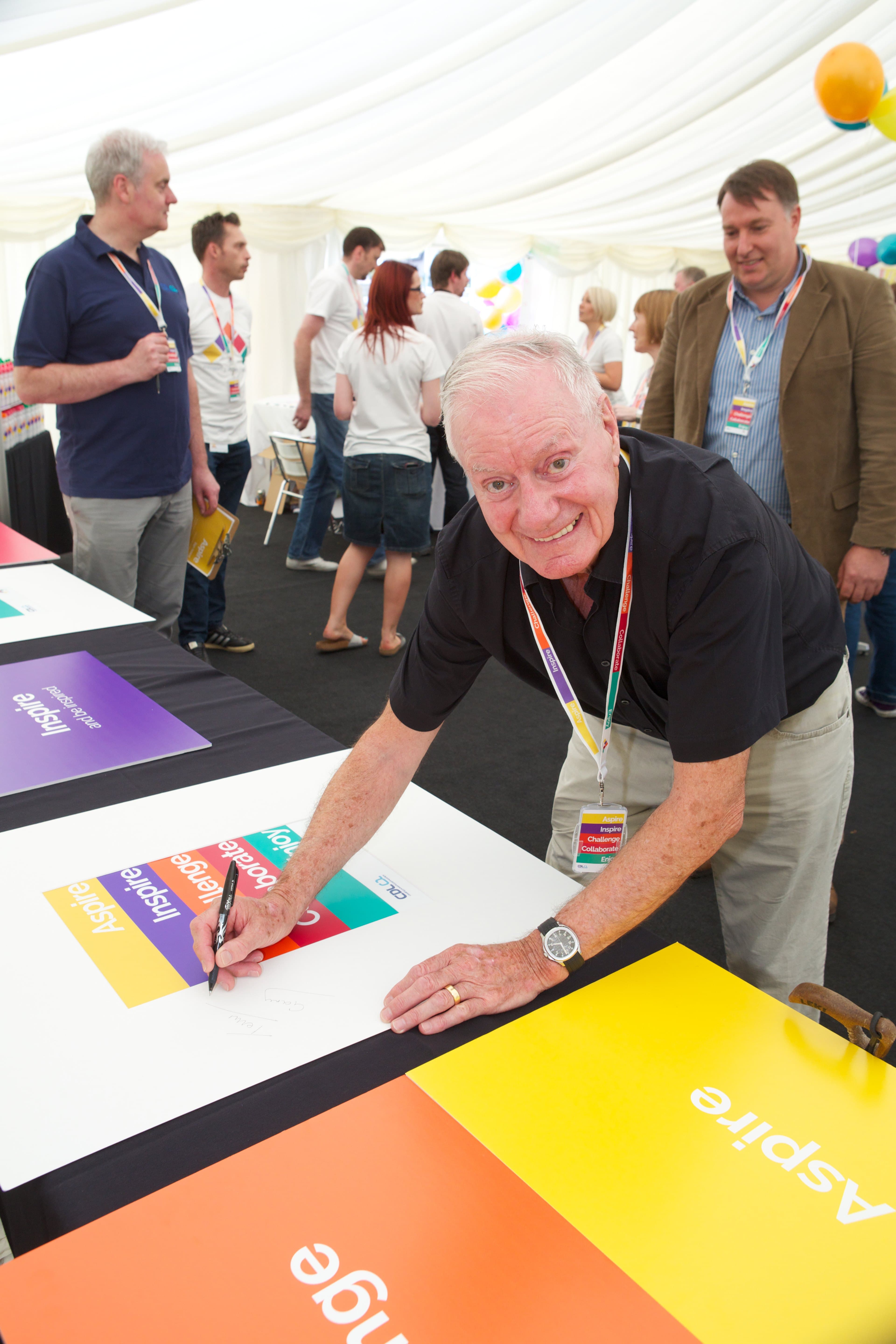 Tom Hogg signs CDL’s mission and values at the 2014 launch